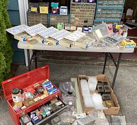 Full view of folding table with hardware organizers, compartment trays and small parts boxes
