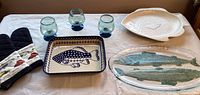 Full view of set showing Boleslawiek Polish Pottery dish, large glass fish tray, ceramic fish tray, three blue glass stemware, and oven mitts