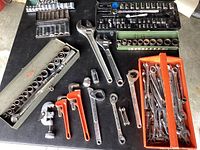 Overall view of all hand tools laid out on table.