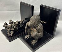 Two Bombay Co. bookends, one with gorilla figure and rope, other with group of monkeys playing with rope, shown from side and angled views.