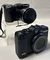 SX420 IS and G15 cameras displayed side by side at slight angle
