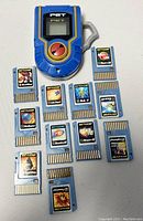 Top view showing MegaMan PET device with the screen, button, and 11 different Battle Chip cartridges arranged below it.