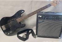 Both amplifier and bass guitar side by side on white backdrop