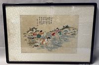 Photo of the framed watercolor painting depicting women washing clothes by a river with Chinese calligraphy and seals.