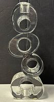 Four clear circular crystal candleholders stacked vertically showing Mikasa signature on one piece