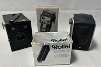 The Rolle Beta 3 electronic flash with its original white and black box, displayed alongside the Kodak Duaflex camera and the Micu Vue slide viewer.