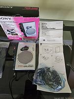 Sony Stereo Walkman TCS-300 with original box, manual, earphones, cables on glass surface