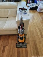Front view of assembled Dyson DC24 upright vacuum on hardwood floor