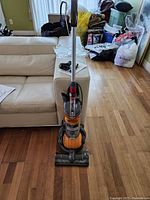 Front view of upright Dyson DC24 Ball vacuum on hardwood floor