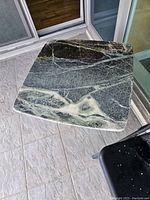 Top view of the square verde green marble end table showing natural veins and patterns on polished stone surface.