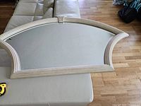 Full view of the decorative mirror showing the unique shape and seashell motif at the top center of the frame.