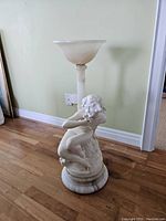Full view of the marble and frosted glass romanesc plant stand with female sculpture base
