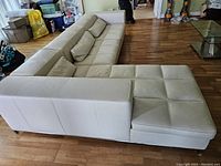 Side view showing the L-shaped layout with chaise on left and sofa on right.