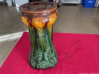 Full view of the Majolica stand showing flower and leaf patterns with brown top rim.