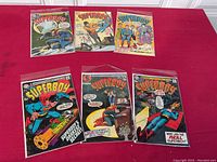 Six Superboy comic books laid out, showing covers of issues including 160, 161, and 162 with colorful artwork of Superboy in various scenes.