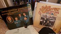 Photo shows vinyl album covers of Porter Wagoner and the Blackwood Brothers Quartet and John Denver.