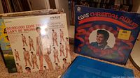 Photo showing Elvis Presley albums including 'Elvis Christmas Album' with a shrink wrap and price sticker and '50,000,000 Elvis Fans Can't Be Wrong' album.