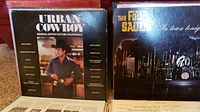 Vinyl albums including Urban Cowboy original motion picture soundtrack and The Four Seasons In Town Tonight with visible album covers showing used condition.