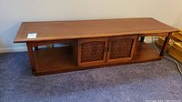 Full view of mid century modern coffee table with rectangular top and open shelf design showing overall condition and style.
