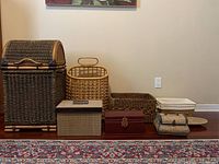 Photo showing the entire lot with seven decorative storage pieces placed on floor.