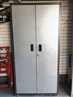 Full front view of steel cabinet with closed doors and inset handles