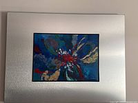 Overall view of the framed abstract floral painting on board, showing the entire composition and silver mat border