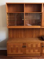 Overall front view of teak cabinet showing upper glass doors and lower wood doors