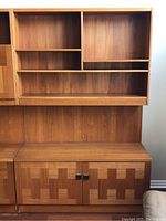 Front view of upper open shelving and lower closed cabinet