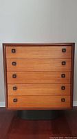 Full front view of teak highboy dresser showing overall style and condition