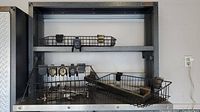 Full Gladiator wall mount frame showing attached wire baskets and hooks, highlighting overall condition and setup.