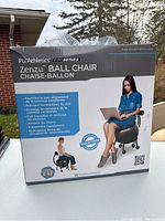 Photo of the front of the PurAthletics Zenzu Pro Series Ball Chair box showing product name in English and French, highlighting benefits like spinal alignment, pain relief, and muscle strengthening.