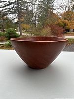 Side view of the large wooden salad bowl showing tapered shape and wood grain