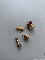 Photo of the set showing the mini crown with purple velvet, gold orb with cross, gold scepter, and brass wax seal stamp.