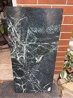 Front view of the green marble slab showing polished surface with white veining.