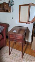 End table with two dovetailed drawers, wooden polished reddish-brown finish, showing some wear.