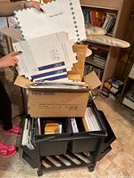 Rolling office caddy packed with mailing boxes, envelopes, assorted papers and office supplies