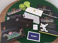 Overview of entire collection displayed on green surface, showing all brochures, envelopes, tickets and commemorative items