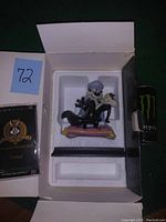 Figurine still in original box with Styrofoam protective casing and booklet included.