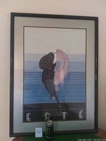 Front view of framed ERTE Black Panther Coat artwork showing entire art, matting and frame with a Monster energy can for scale.