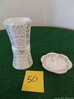 Photo of Wallen Mills Royal Tara fine bone china vase and ring holder set showing embossed Celtic knot design, shamrocks, and gold trim.