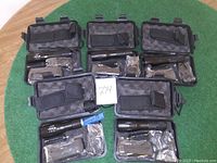 Five black protective cases each containing an LED rechargeable flashlight and accessories.