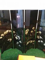 Front side of the folding screen showing multiple pandas on tree branches surrounded by nature.