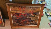 Full view of the framed print featuring red maple branches and a textured water background.