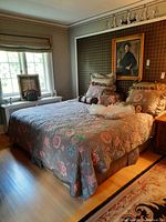 King size bed assembled with floral bedding and decorative pillows, shown in bedroom setting.