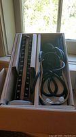 Top view of Baumanometer blood pressure monitor alongside stethoscope inside the original packaging box.