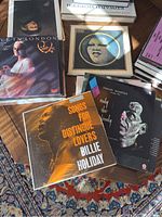 Multiple vinyl LP covers laid out on wooden floor, including Peggy Lee 'Live in London', Beethoven 9 Symphonies box, Billie Holiday and Frank Sinatra albums