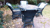 Table and four chairs arranged outdoors