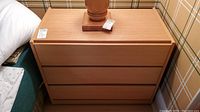 Front view showing three drawers closed and overall appearance