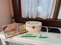 Full lot overview showing all items arranged on white table by window with sheer curtain background
