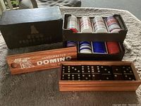 Photo showing the open display of poker chips in trays and the handcrafted domino set in its wooden box.